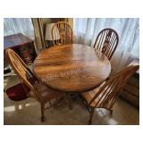 Oak round dining table and four chairs