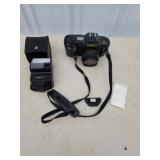 Vintage Canon T70 35mm camera with flash