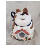 Vintage kitten sitting on birdhouse cookie jar Vintage kitten sitting on birdhouse cookie jar
