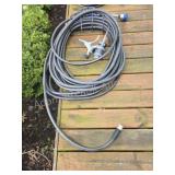 Decorative wrought iron hose hanger with hose and