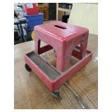 Red plastic rolling mechanics seat
