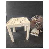 Vintage oscillating fan and a small plastic table