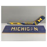 U of M wooden hockey stick and homemade sign