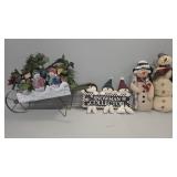 Snowman wheelbarrow, sign, stuffed animals