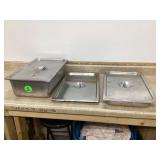 Three stainless steel pans with lids