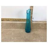 Tiny blue glass vase swinging