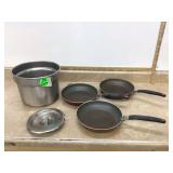 3 skillets and steel container
