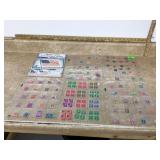 Five plastic sleeves of US stamps with 2024 catalog