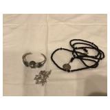 Shiny silver bracelet brooch and charms