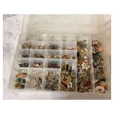 Various earrings in divided container Various earrings in divided container