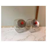 Two large vintage canisters one with advertisement