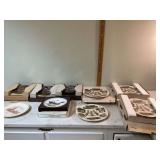 Various decorative plates in storage tote