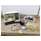 Old Kenmore sewing machine with accessories