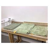 Green bathmats in basket