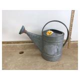 Old metal watering can