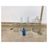 Collection of bottles with flower frog insert