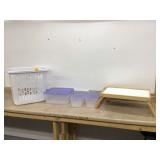 Three totes with lids and lap tray in laundry basket