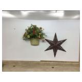Metal star and fake flowers in metal pot