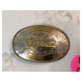 Western-themed belt buckle showcasing team roping