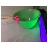 Antique green glass bowl glows under UV light