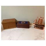 Two wooden boxes and a plastic model ship