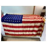 Vintage 48-star flag with wear and small holes