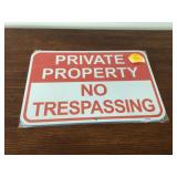 Metal signs with phrase Private Property No Trespassing