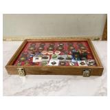 Global collection of Hard Rock Cafe pins and keychains displayed in case
