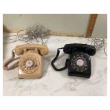 Two vintage rotary desk phones 1 beige pink 1 black