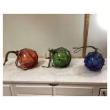 3 colored glass buoys with net
