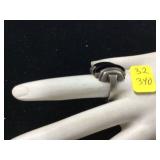 Silver ring with black stone unmarked weighs 64 grams