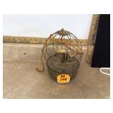A vintage birdcage-shaped music box