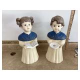 Tall ceramic candleholders with choir boy and girl designs