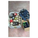 Lot of new and used softballs, bowling ball and