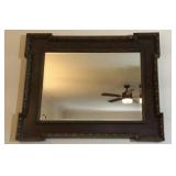 Large framed carved wood wall mirror.  Frame is