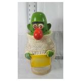 Hard plastic green character in vase coin bank