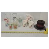 Painted glasses, pitcher, candle