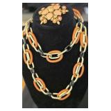 Assorted necklaces and brooches.