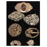 Dark metal brooches