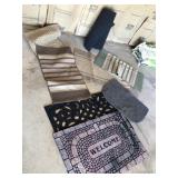 Assortment of throw rugs and welcome mats