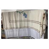 Blanket with flowers has a few holes and stains