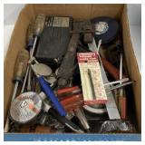 Box of tools including saw blade, electrical tape