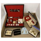 Flat of tie clips , cuff links and bracelets.