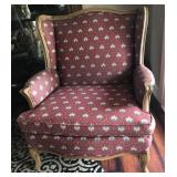 Red flowered wing chair with wood trim