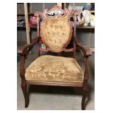 Ornately carved wooden chair with decorative