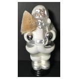 Statue of Santa Claus carrying Christmas tree