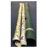 3 bolts of fabric with varying prints