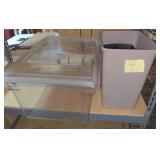 Two trash bins and a clear storage bin