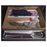 Silver serving utensils and silk scarf