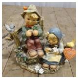 (P) Hummel boy and girl by fence
